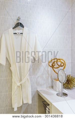 White Bathrobe Decoration On A Hanger In Bathroom Interior