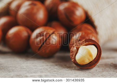 Macadamia Nut On A Wooden Table In A Bag, Closeup, Top View