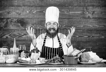Happy Bearded Man Cooking In Kitchen. Dieting With Organic Food. Fresh Vegetables. Vitamin. Man Use 