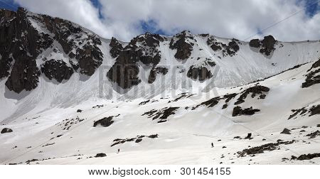 Panoramic View On High Mountains With Snow Cornice And Avalanche Trail, Snowy Plateau And Two Small 