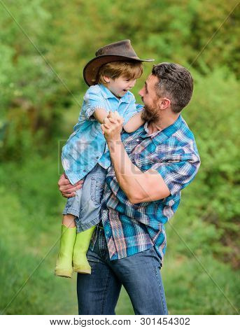 Small Boy Child Help Father In Farming. Father And Son In Cowboy Hat On Ranch. Kid In Rubber Boots. 