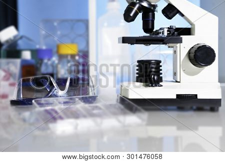 Entry Level Miicroscope And Plastic Safety Glasses In Scientific Lab