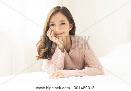 Portrait Of Young Asian Woman Smiling Friendly And Looking At Camera In Living Room.woman's Face Clo