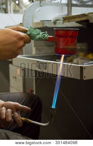 The Lunch Break Of The Master Jeweler And He Warms The Tea In An Iron Mug By Jewelery Burner