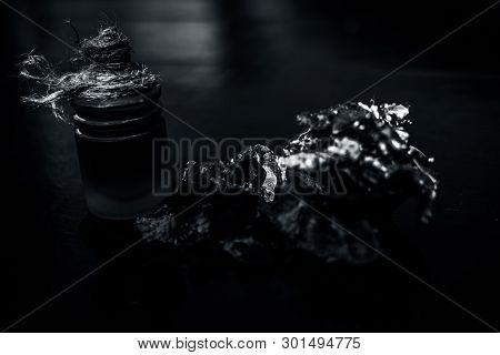 Raw Organic Amli Or Tamarind Or Imli In A Clay Bowl On Wooden Surface With Its Extracted Herbal Esse