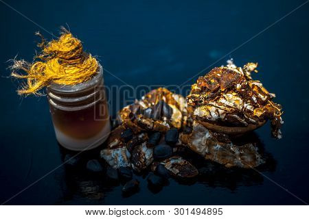 Raw Organic Amli Or Tamarind Or Imli In A Clay Bowl On Wooden Surface With Its Extracted Herbal Esse
