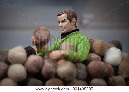 MAY 15 2019: Recreation of a scene from Star Trek Original Series episode The Trouble with Tribbles. Captain Kirk covered by a pile of Tribbles. Mego action figure used.