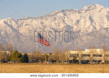 American Flag And Building With Mount Timpanogos And Sky In The Background