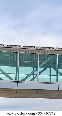 Vertical Looking Up At An Empty Skybridge With A Cloudy Blue Sky In The Background