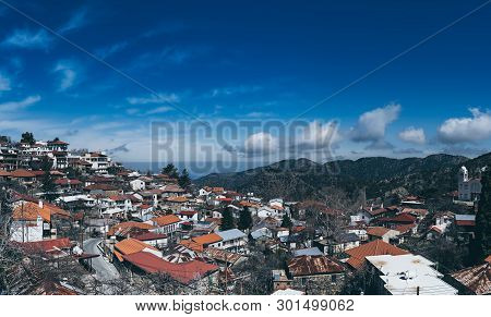 Pedoulas Village On Cyprus In Troodos Mountains With Blue Sky And Copy Space. Panoramic View.