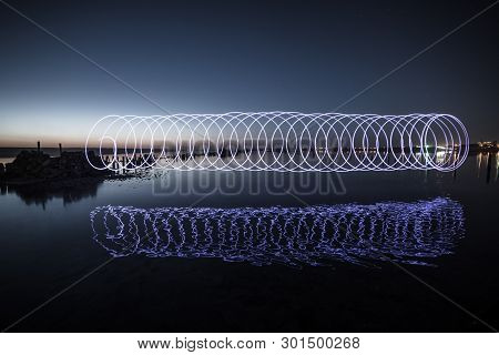 Amazing Laser Fireshow Performance In The Night Blue Sky With Reflections In The Sea Water