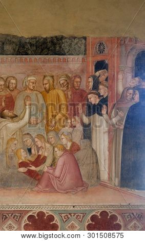 FLORENCE, ITALY - JANUARY 10, 2019: Miracle of the saint, detail from St Peter of Verona preaching, fresco by Andrea di Bonaiuto, Spanish Chapel in Santa Maria Novella church in Florence, Italy