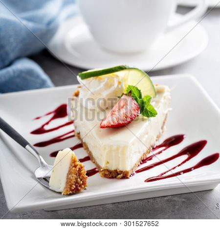 Key Lime Pie Slice Served On A Plate With A Piece Taken