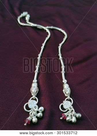 Indian Traditional Leg Wear Jewelry Payal Or Kandora On Violet Background