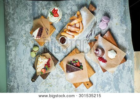 Assorted Sweet Desserts. Top View. Gray Textured Background. Beautiful Serving Dishes. Dessert. Food