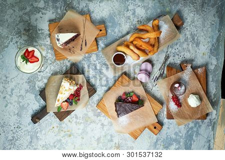 Assorted Sweet Desserts. Top View. Gray Textured Background. Beautiful Serving Dishes. Dessert. Food