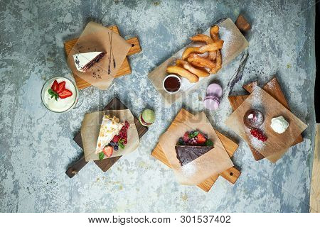 Assorted Sweet Desserts. Top View. Gray Textured Background. Beautiful Serving Dishes. Dessert. Food