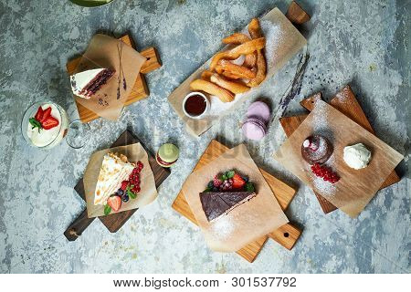 Assorted Sweet Desserts. Top View. Gray Textured Background. Beautiful Serving Dishes. Dessert. Food