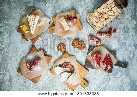 Assorted Sweet Desserts. Top View. Gray Textured Background. Beautiful Serving Dishes. Dessert. Food