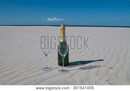 A Champagne Bottle Built On The Beach, White Sand And Blue Sea Is A Holiday In Paradise.