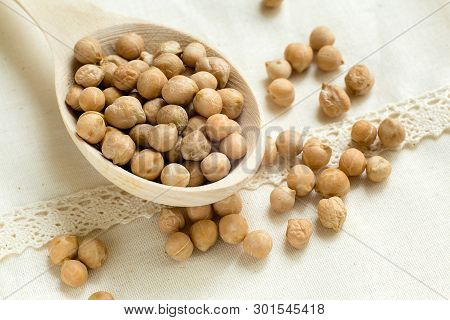 Dry Raw Organic Chickpeas In Wooden Spoon Isolated On White Background, Close Up