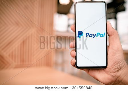 Chiang Mai, Thailand - Mar. 23,2019: Man Holding Xiaomi Mi Mix 3 With Paypal Apps On The Screen. Pay