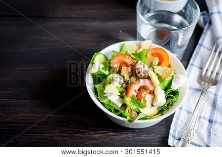 Fresh Light Green Salad With Cucumber, Lettuce, Avocado, Tomatoes, Cheeseand Sseeds And Glass Water 