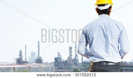 Male Engineer Is Working At The Refinery.