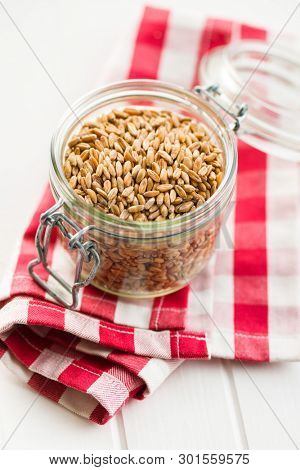 Healthy spelt grains in jar.