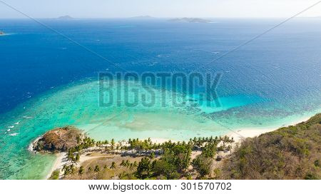 Aerial Seascape Tourists Enjoy The Tropical Beach. Tropical Island With Sand Beach, Palm Trees. Malc