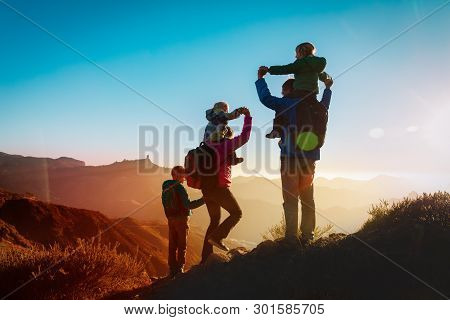 Happy Family Travel In Mountains At Sunset