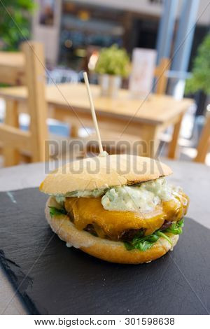 Burger with cheese and lettuce.