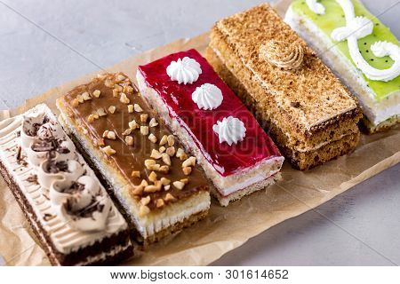 Assorted Different Mini Cakes With Cream Coffee Chocolate Salted Caramel And Berries Above Horizonta