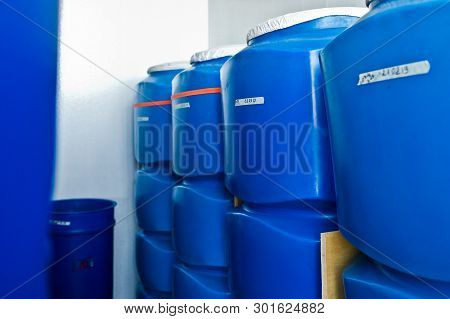Plastic Barrel. Barrel On A Pallet With A Metal Frame. Shipment Of Chemicals. Plastic Container For 