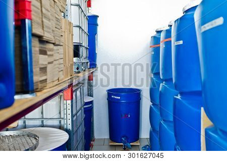 Plastic Barrel. Barrel On A Pallet With A Metal Frame. Shipment Of Chemicals. Plastic Container For 
