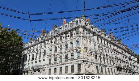 Tangle Of Electric Wires At An Intersection Between Tram Lines