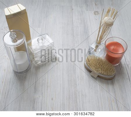 Cosmetic Flatlay On Grey Wooden Table. Beauty Set Of Plastic Containers With Q-tips, Disks, Bottle, 