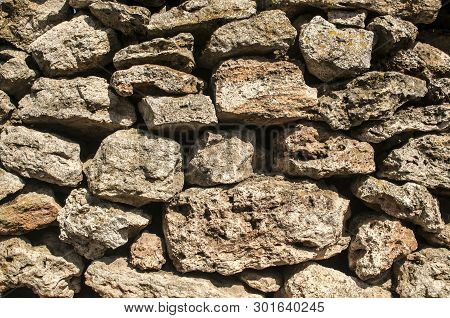 Old Rural Dry Masonry Stone Wall Closeup As Stone Background