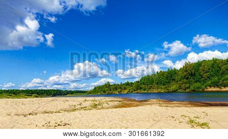 Wild Sandy Beach Near The River On A Fine Summer Day. Only Blue Sky, Sand And A Quiet River. Russia,