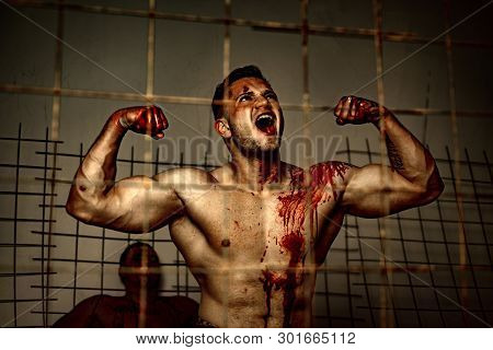 Scary Monster Just Murdered His Victim. Strong Aggressive Monster Behind Grid. Prison For Monster. P