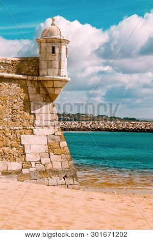 Castle Of Lagos In Portugal; Part Of The Castle Wall With A Watch Tower, Toned Image