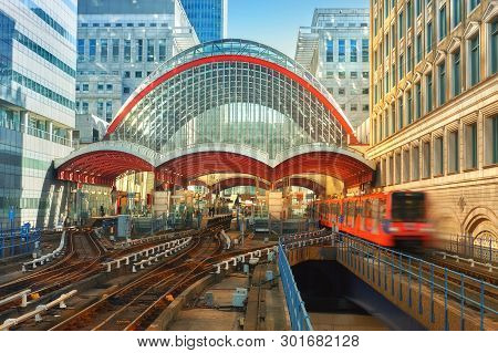 London, England - May 5, 2013: Canary Wharf, Dlr Station In London, Uk. Dlr Train Leaving The Statio