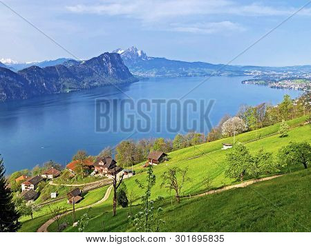 View Of Lake Lucerne Or Vierwaldstaetersee With Vitznau Settlement And Swiss Alps In The Background 