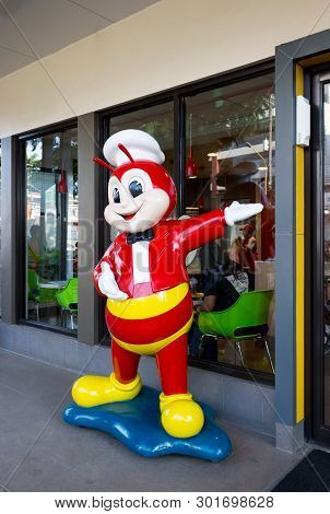Palawan, Philippines - September 27, 2018: Jollibee Fast Food Restaurant With Mascot At Entrance Is 