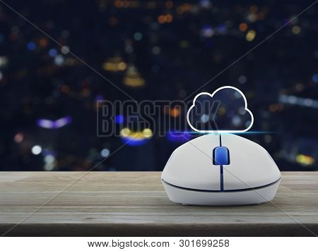 Cloud Icon With Copy Space And Wireless Computer Mouse On Wooden Table Over Blur Colorful Night Ligh