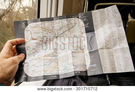Paris, France - Jan 30, 2018: Man Reading In Fast Rer Train Map Of Parisian New Paris Metro Map With