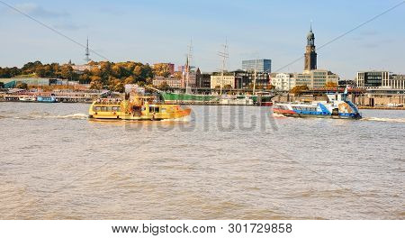 HaМburg, Germany- August 12, 2015: Boat With Tourists Goes On Elbe River In Hamburg With St. Michael