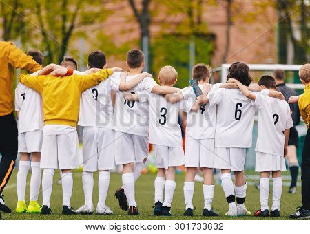 United Youth Sports Team. Football Soccer Teen Players Standing Together With Coach During Penalty K
