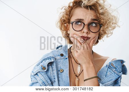 Hesitant Girl Having Deep Thought In Mind Pouting Complicated And Unsure Holding Hand On Chin While 