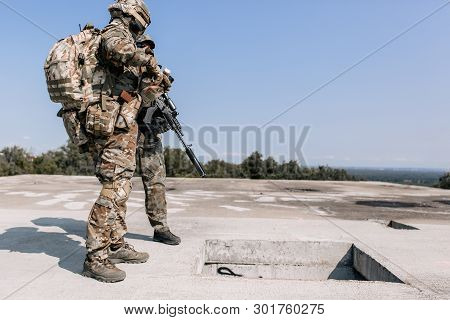 Army Soldiers During A Military Operation Standing With Sniper Rifles, Storming The Building. Concep